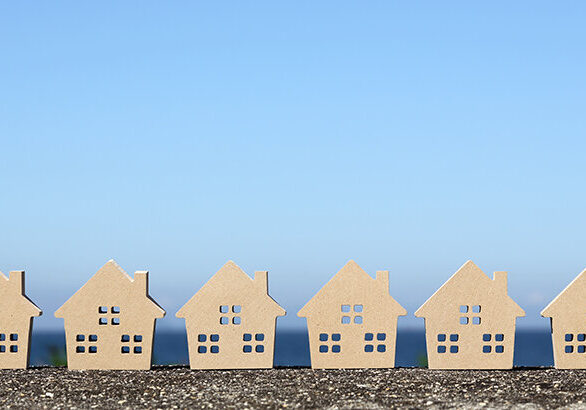 wooden toy house against clear blue sky backgroundwooden toy house against clear blue sky background